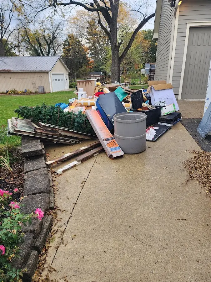 Dumpster being loaded with debris for 12 Yard Dumpster Rental in Lower Burrell
